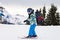 Young child, skiing on snow slope in ski resort in Austria