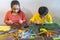 Young children are constructing colorful plastic sticks with glue gun. fun with building geometric figures and learning