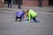 Young children drawing on a street