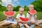 Young children eating watermelon
