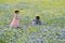 Young Children in Field of Blue Bonnet Flowers