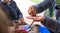 Young children learning how to plant seeds in garden. Narrow depth of field of hands holding seeds and black soil in pot.