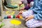 Young children painting on concrete, two anonymous girls engaging in art therapy activities