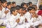 Young children pray in tibetan