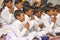 Young children pray in tibetan