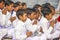 Young children pray in tibetan buddhist monastery Sarnath