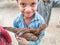 Young children are receiving hen by government`s poverty control program in Pakistan