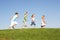 Young children running through field