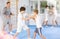 Young children working in pair mastering new self-defense moves at gym