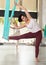 Young chilean woman exercising in aerial yoga studio during group workout