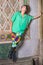 Young Chinese American woman standing against wall in New York City, looking up, thinking