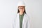 Young chinese engineer woman wearing coat helmet glasses over isolated white background skeptic and nervous, frowning upset