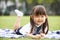 Young Chinese Girl Lying On Blanket In Park