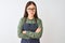 Young chinese shopkeeper woman wearing apron and glasses over isolated white background skeptic and nervous, disapproving