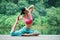 Young chinese woman practicing yoga outdoor