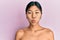 Young chinese woman standing topless showing skin puffing cheeks with funny face