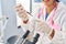 Young chinese woman wearing scientist uniform analysing blood at laboratory