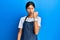 Young chinese woman wearing waiter apron angry and mad raising fist frustrated and furious while shouting with anger