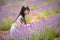 Young Chinese woman in white traditional dress, walking in lavender field. Plateau de Valensole, Alpes-de-Haute-Provence, Provence