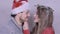 Young Christmas couple enjoying snow over white background