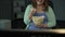 Young chubby woman laughing, commenting on TV show and eating popcorn messily