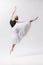 Young classical dancer on white background.