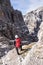 Young climber girl high in the mountains