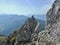 A young climber scaling a rock tower in the Alps