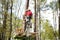 Young climber on a special bike rides on tightrope