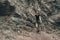 Young climber woman standing near the rock