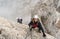 Young climbers on a steep and exposed rock face climbing a Via Ferrata