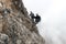 Young climbers on a steep and exposed rock face climbing a Via Ferrata