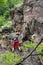 Young climbers train on the rocky wall near the Stura stream