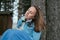 Young closed eyes woman sitting outdoors. Wind in hair