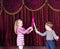 Young Clowns Having Prop Sword Fight on Stage