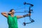 Young colombian woman aims arrow of compound bow