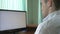 Young computer programmer coding at his desk