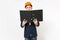 Young concerned businessman in dark suit, protective hardhat holding black folder for papers document and covering face