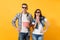 Young concerned couple woman and man in 3d glasses watching movie film on date holding bucket of popcorn and plastic cup