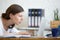 Young concerned office woman looking at laptop computer