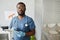 Young confident African-American veterinarian making notes in medical document