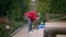 Young confident concentrated African American man collecting garbage in garden. Side view wide shot of focused guy