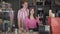 Young confident couple posing in coffee shop at counter in 1980s. Portrait of self-employed Caucasian man and woman