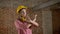 Young confident girl buitder points to work and crosses hands, disagree sign, building concept, brick background