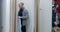 Young confident man choosing shirts during Black Friday sales. Portrait of confident Caucasian male shopper entering