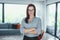 Young confident modern businesswoman posing in living room