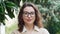 Young confident professional business woman standing outdoor, headshot portrait.