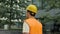 Young construction engineering student walking along the new building.