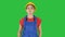 Young construction woman in hardhat walking on a Green Screen, Chroma Key.