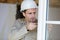 young construction worker fitting window